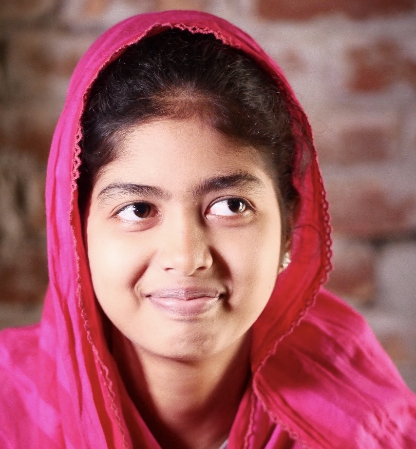 Smiling girl in a pink headscarf